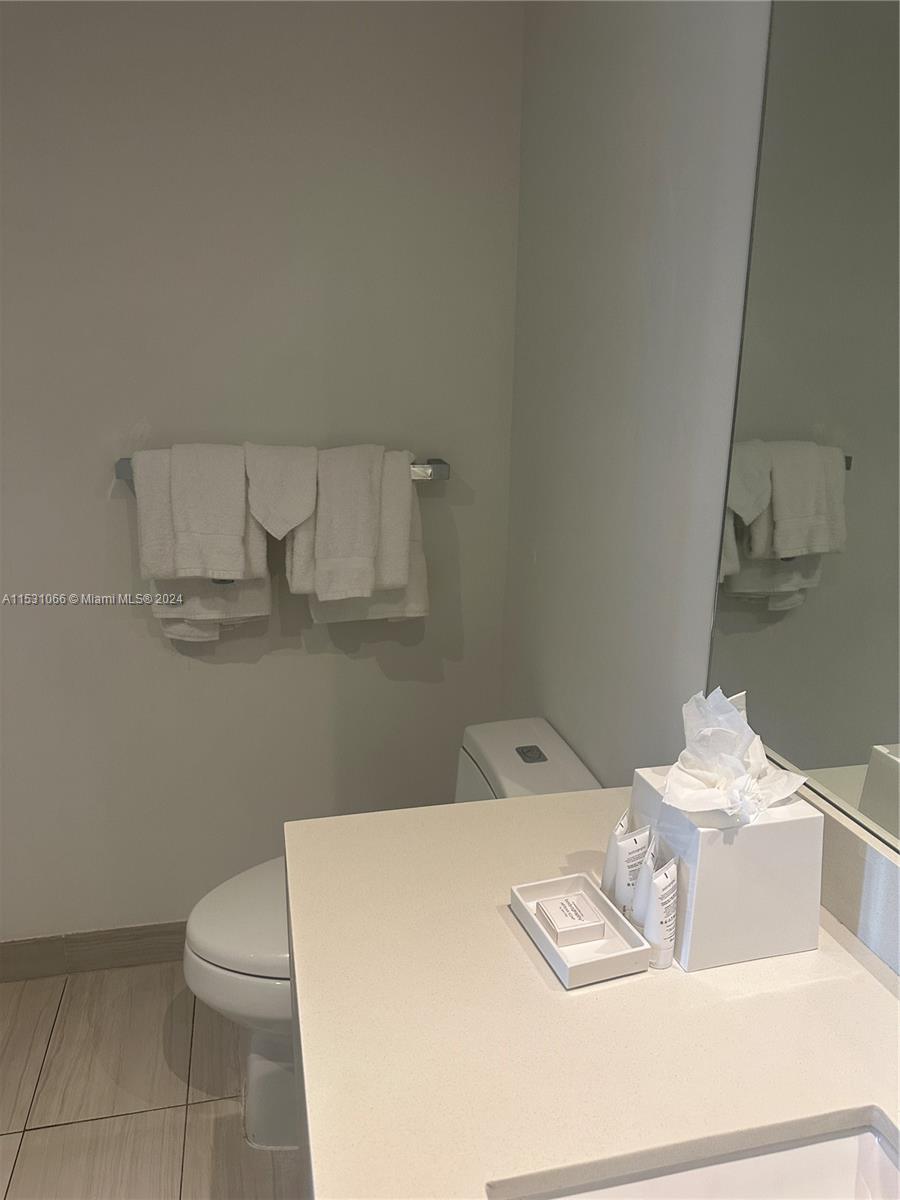 4010 South Ocean Drive, Unit R707 Hollywood, FL 33019 - Photo 28 of 70 a bathroom with a sink a toilet and a mirror