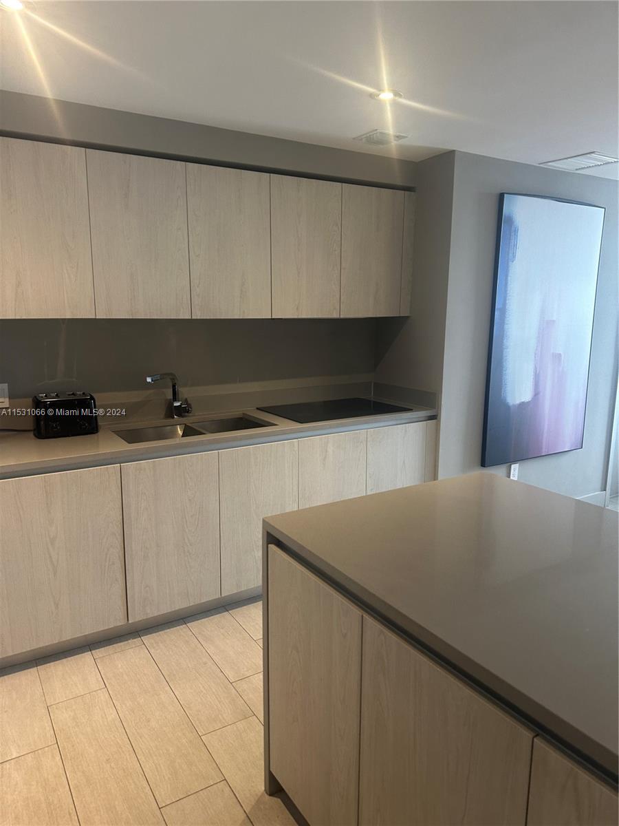 4010 South Ocean Drive, Unit R707 Hollywood, FL 33019 - Photo 30 of 70 a kitchen with stainless steel appliances a refrigerator sink and cabinets