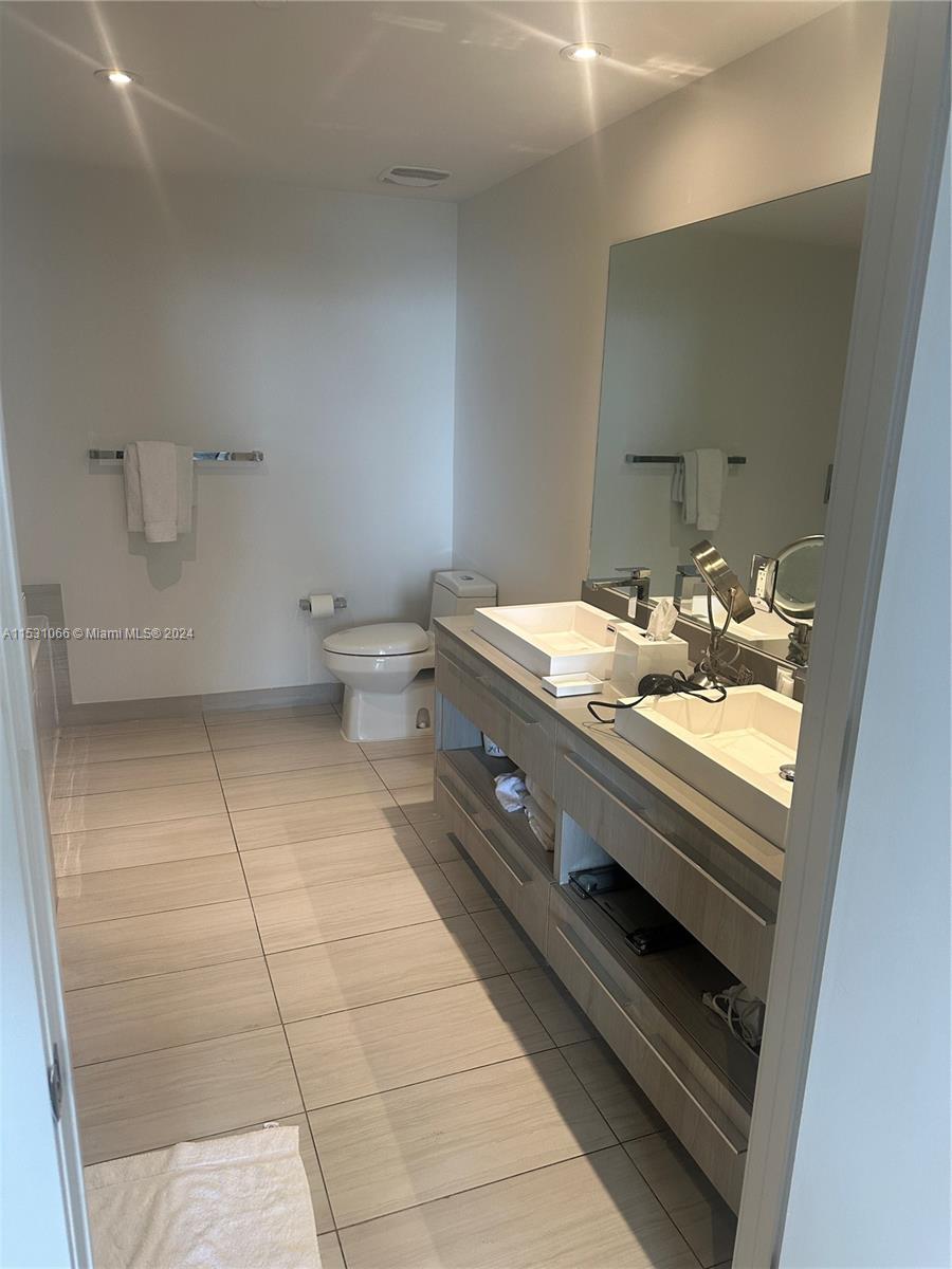 4010 South Ocean Drive, Unit R707 Hollywood, FL 33019 - Photo 35 of 70 a bathroom with a sink a toilet and a mirror