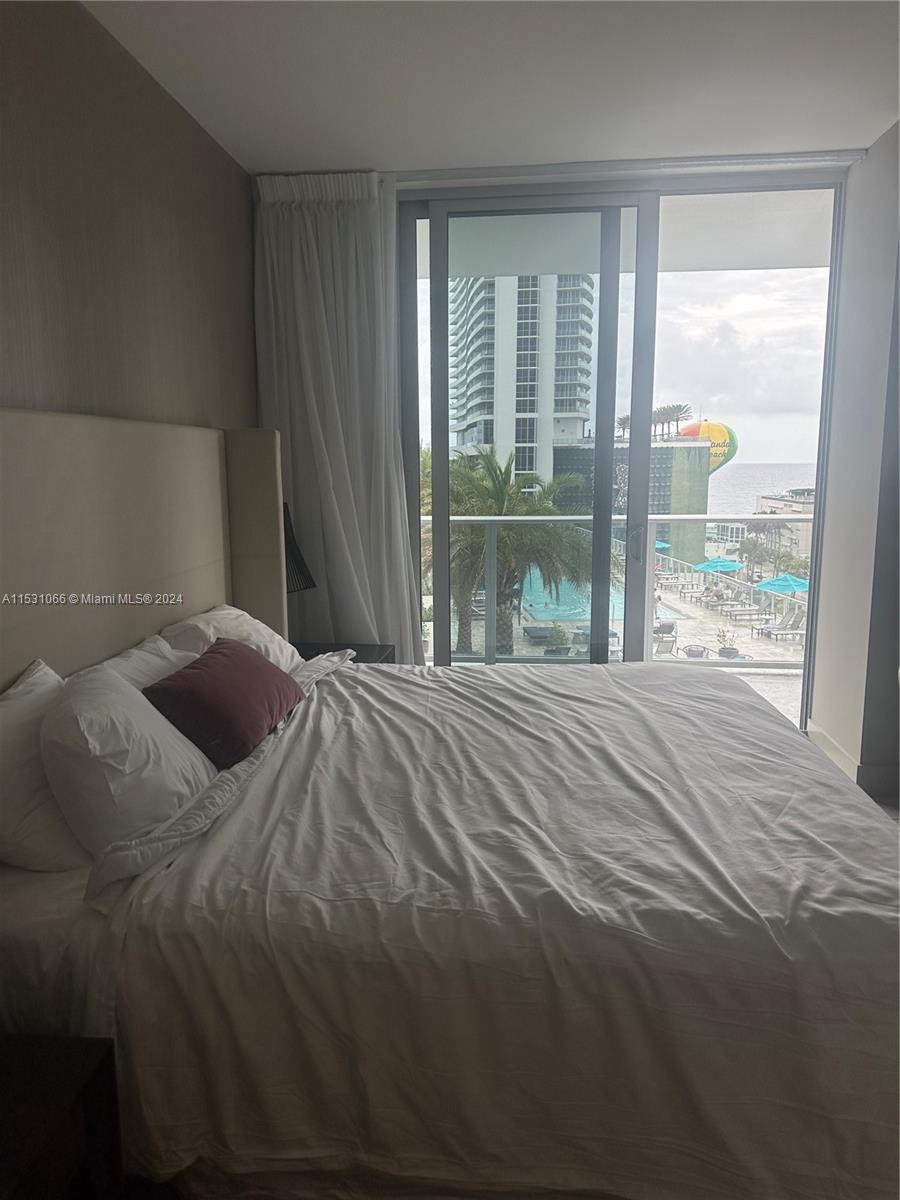 4010 South Ocean Drive, Unit R707 Hollywood, FL 33019 - Photo 38 of 70 a bedroom with a bed and window