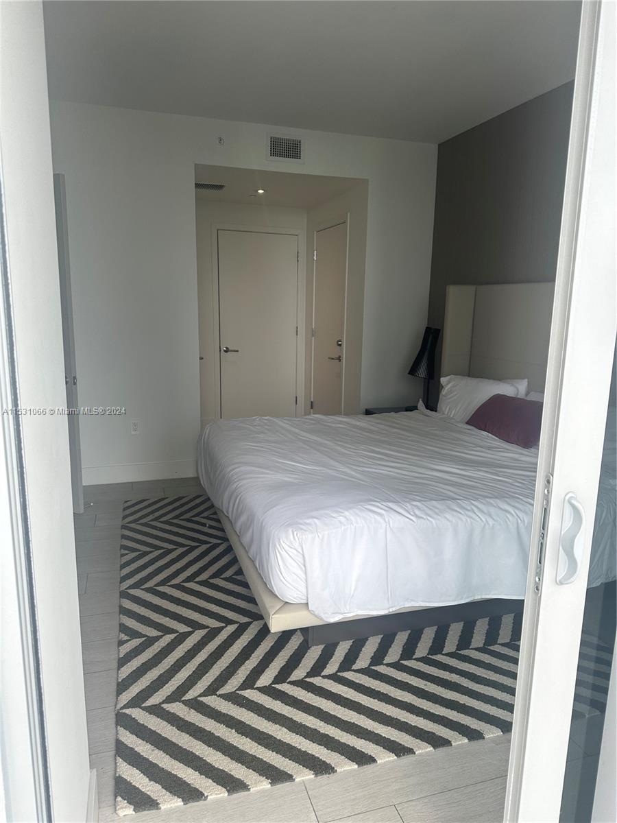 4010 South Ocean Drive, Unit R707 Hollywood, FL 33019 - Photo 40 of 70 a bedroom with a bed and a window