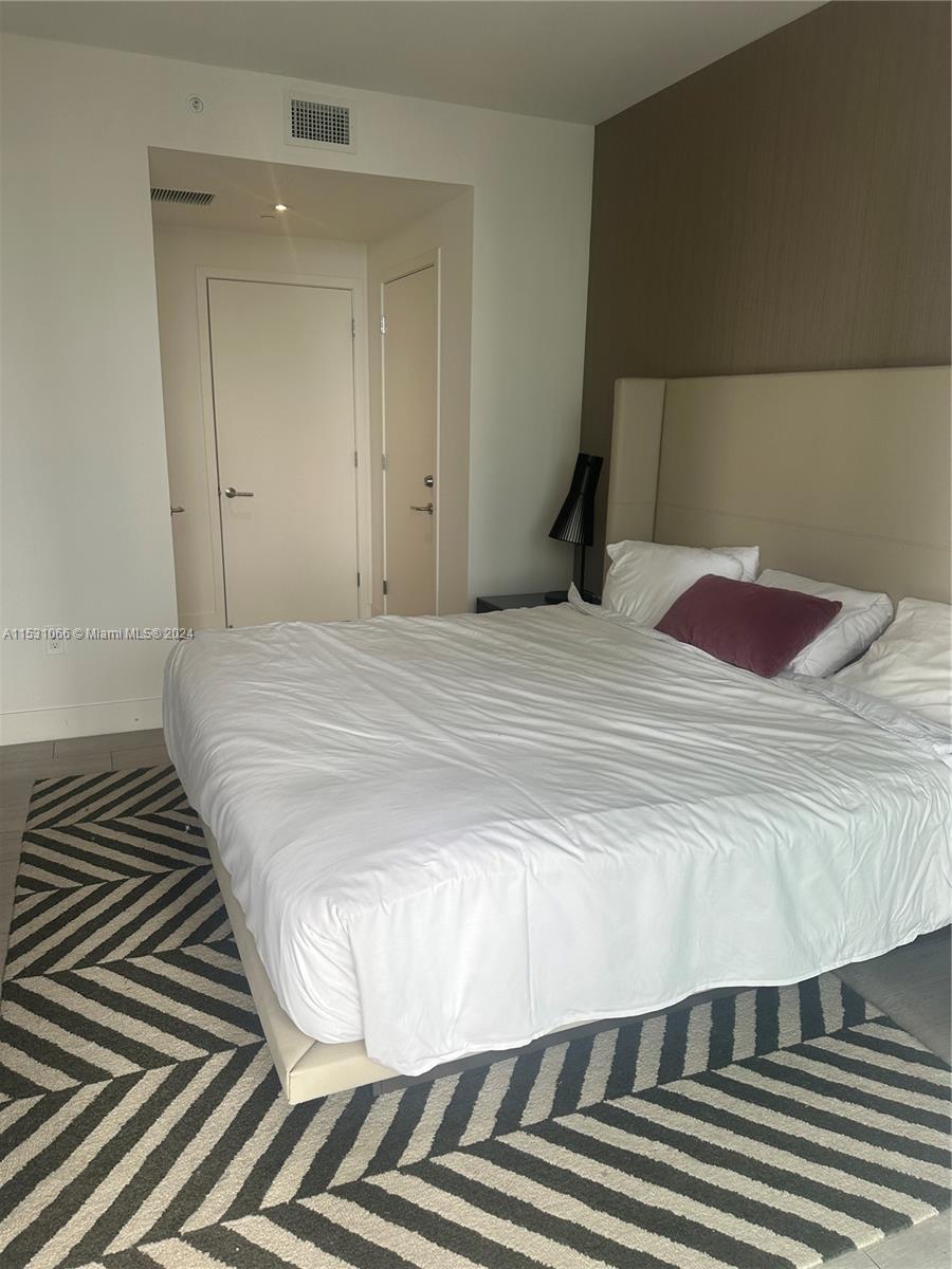 4010 South Ocean Drive, Unit R707 Hollywood, FL 33019 - Photo 42 of 70 a bedroom with a bed and a mirror