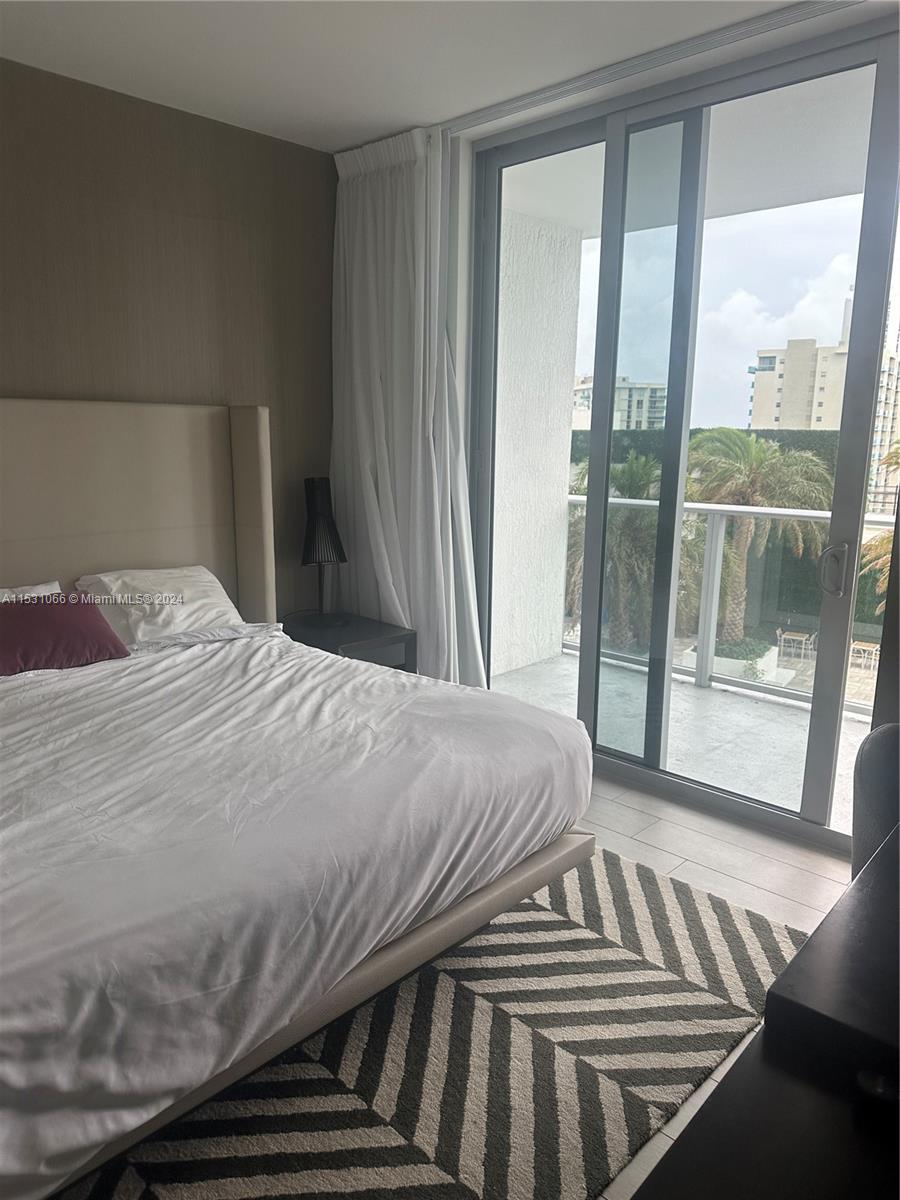 4010 South Ocean Drive, Unit R707 Hollywood, FL 33019 - Photo 55 of 70 a bedroom with a bed and glass window