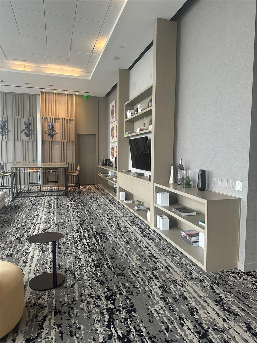 4010 South Ocean Drive, Unit R707 Hollywood, FL 33019 - Photo 61 of 70 a living room with a couch and a flat screen tv