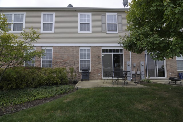565 Springbrook Trail North Oswego, IL 60543 - Photo 2 of 21 a view of a house with a yard and sitting area