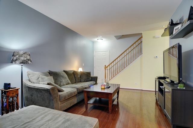 565 Springbrook Trail North Oswego, IL 60543 - Photo 6 of 21 a living room with furniture and a flat screen tv