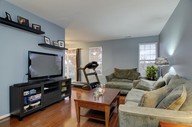 565 Springbrook Trail North Oswego, IL 60543 - Photo 7 of 21 a living room with furniture and a flat screen tv