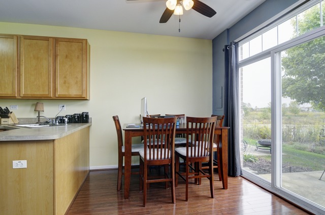 565 Springbrook Trail North Oswego, IL 60543 - Photo 9 of 21 a view of a dining room with furniture window and wooden floor