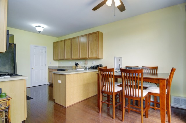 565 Springbrook Trail North Oswego, IL 60543 - Photo 10 of 21 a view of a dining room with furniture and wooden floor
