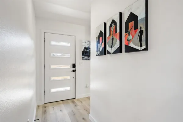 an entryway with wooden floor