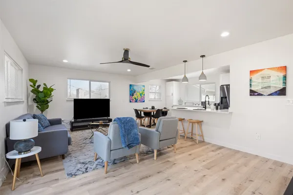 a living room with furniture a fireplace and a flat screen tv