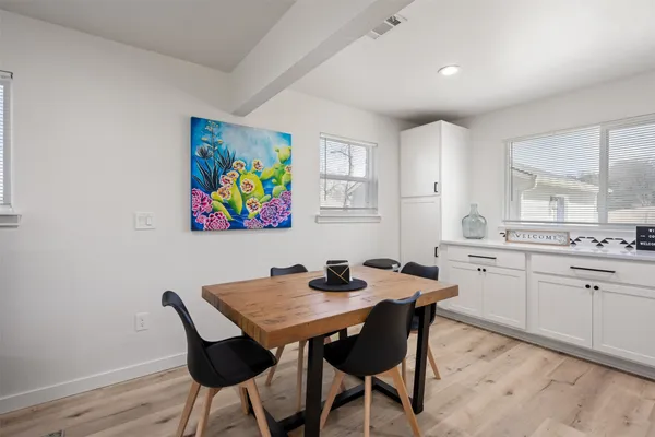 a view of a dining room with furniture and wooden floor