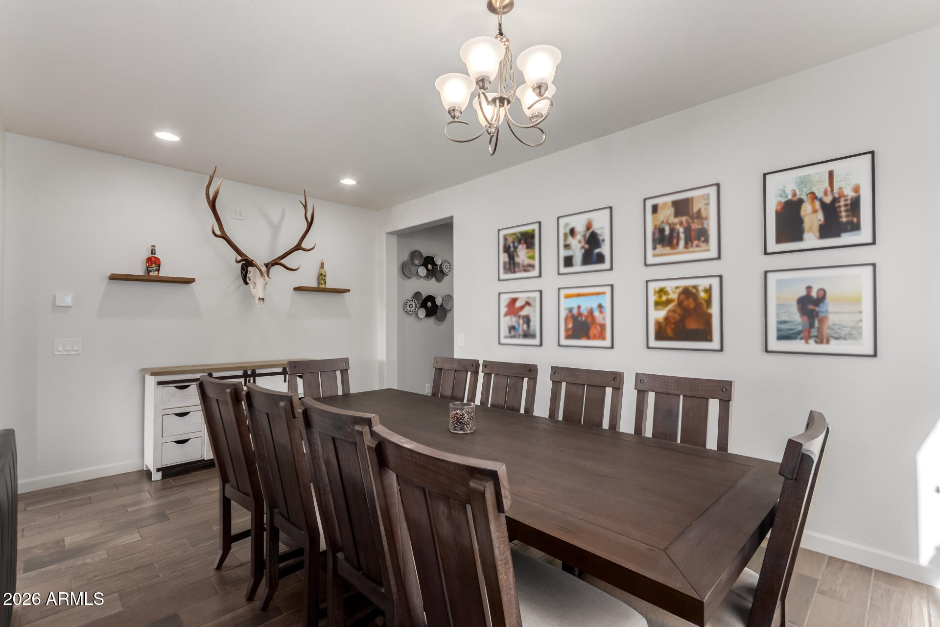 22083 East Camacho Road Queen Creek, AZ 85142 - Photo 10 of 42 a view of a dining room with furniture and chandelier