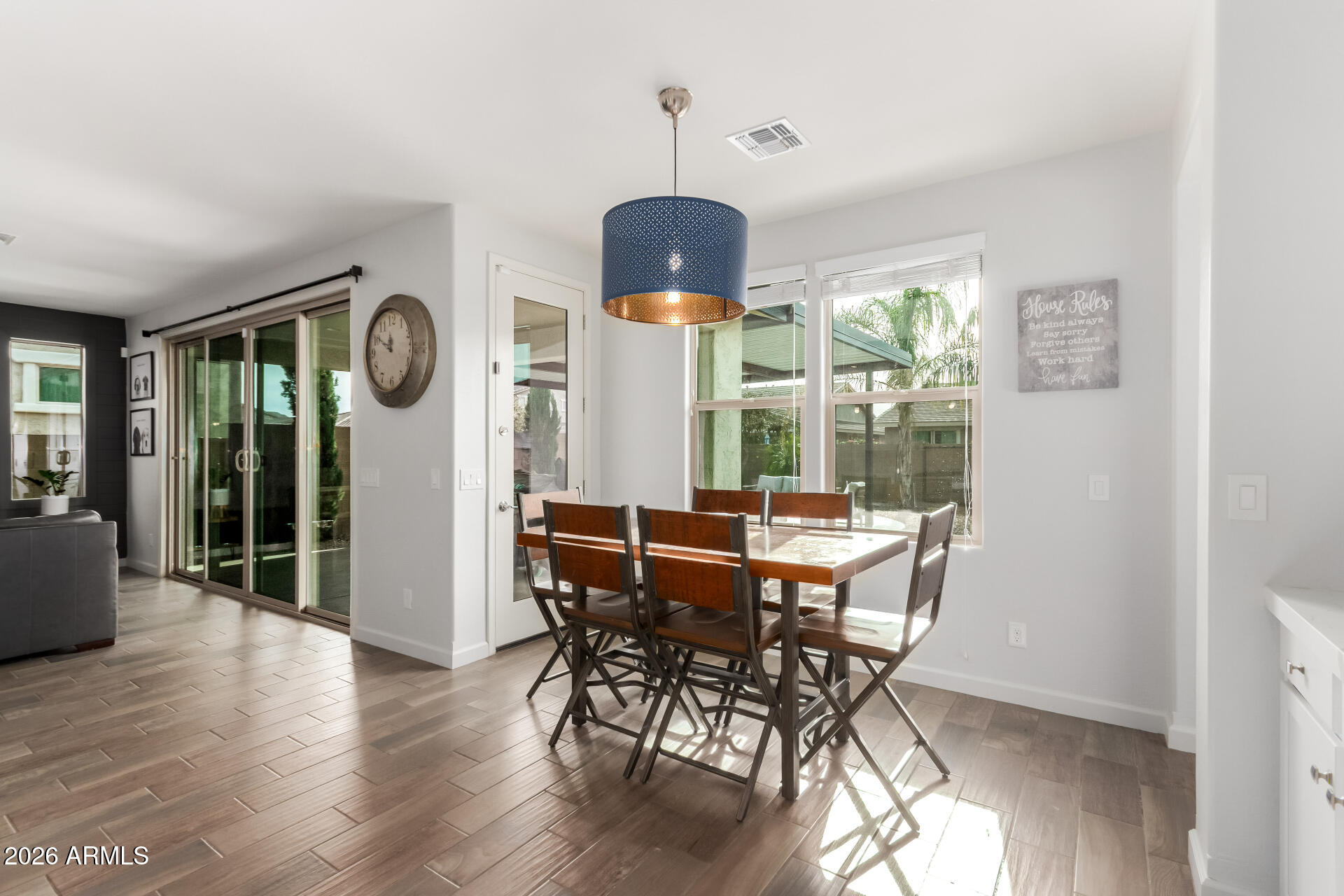 22083 East Camacho Road Queen Creek, AZ 85142 - Photo 14 of 42 a view of a dining room with furniture window and wooden floor