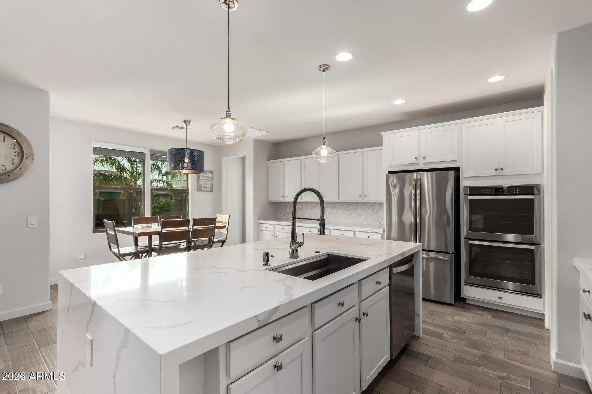 22083 East Camacho Road Queen Creek, AZ 85142 - Photo 15 of 42 a kitchen with stainless steel appliances granite countertop a sink a stove and a refrigerator
