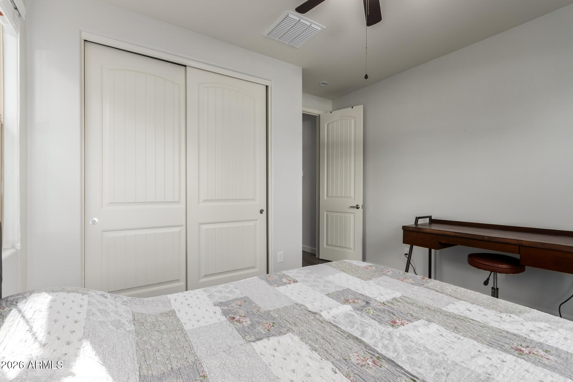 22083 East Camacho Road Queen Creek, AZ 85142 - Photo 26 of 42 a bedroom with a bed and a chandelier