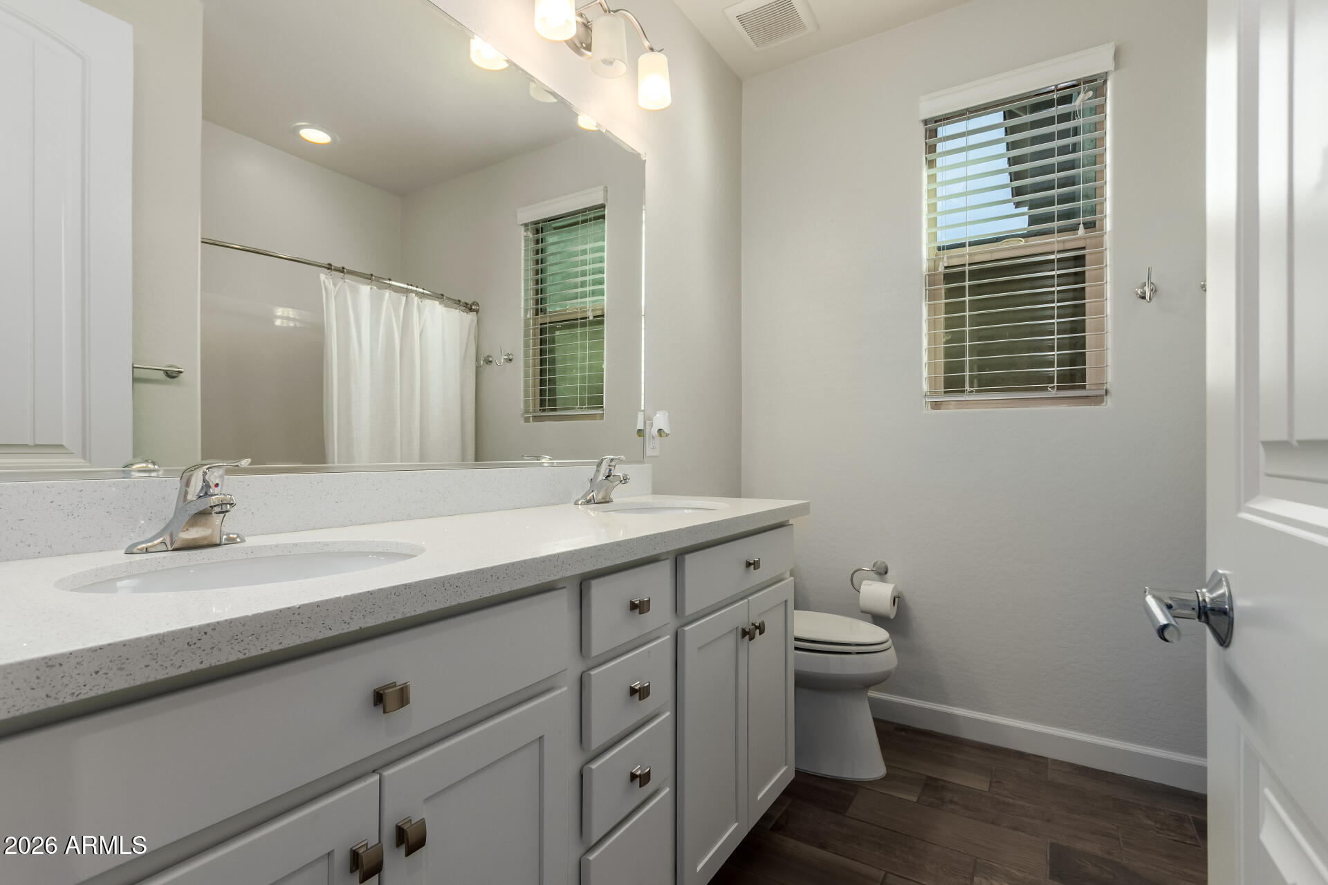 22083 East Camacho Road Queen Creek, AZ 85142 - Photo 27 of 42 a bathroom with a granite countertop sink toilet and a mirror