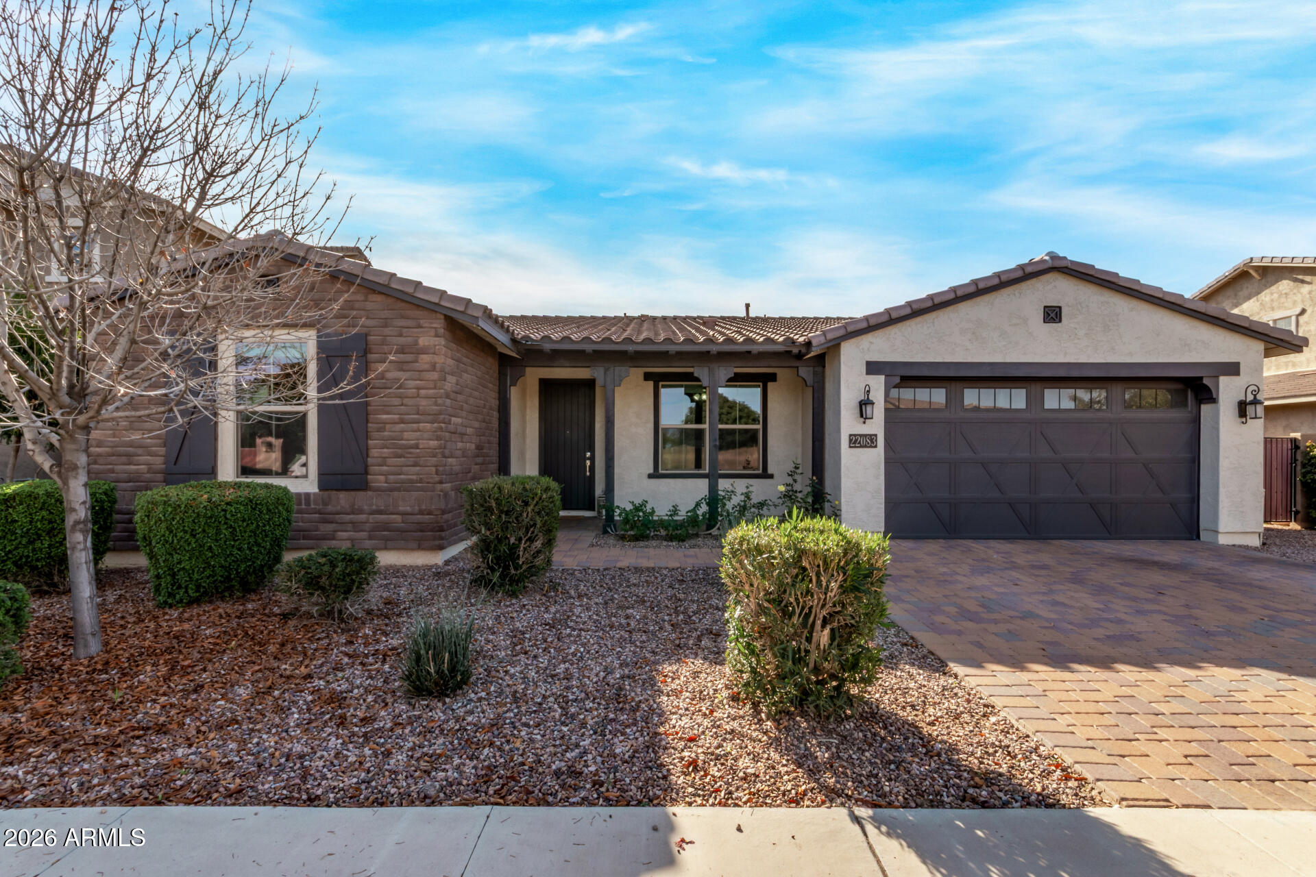 22083 East Camacho Road Queen Creek, AZ 85142 - Photo 2 of 42 a front view of a house with garden