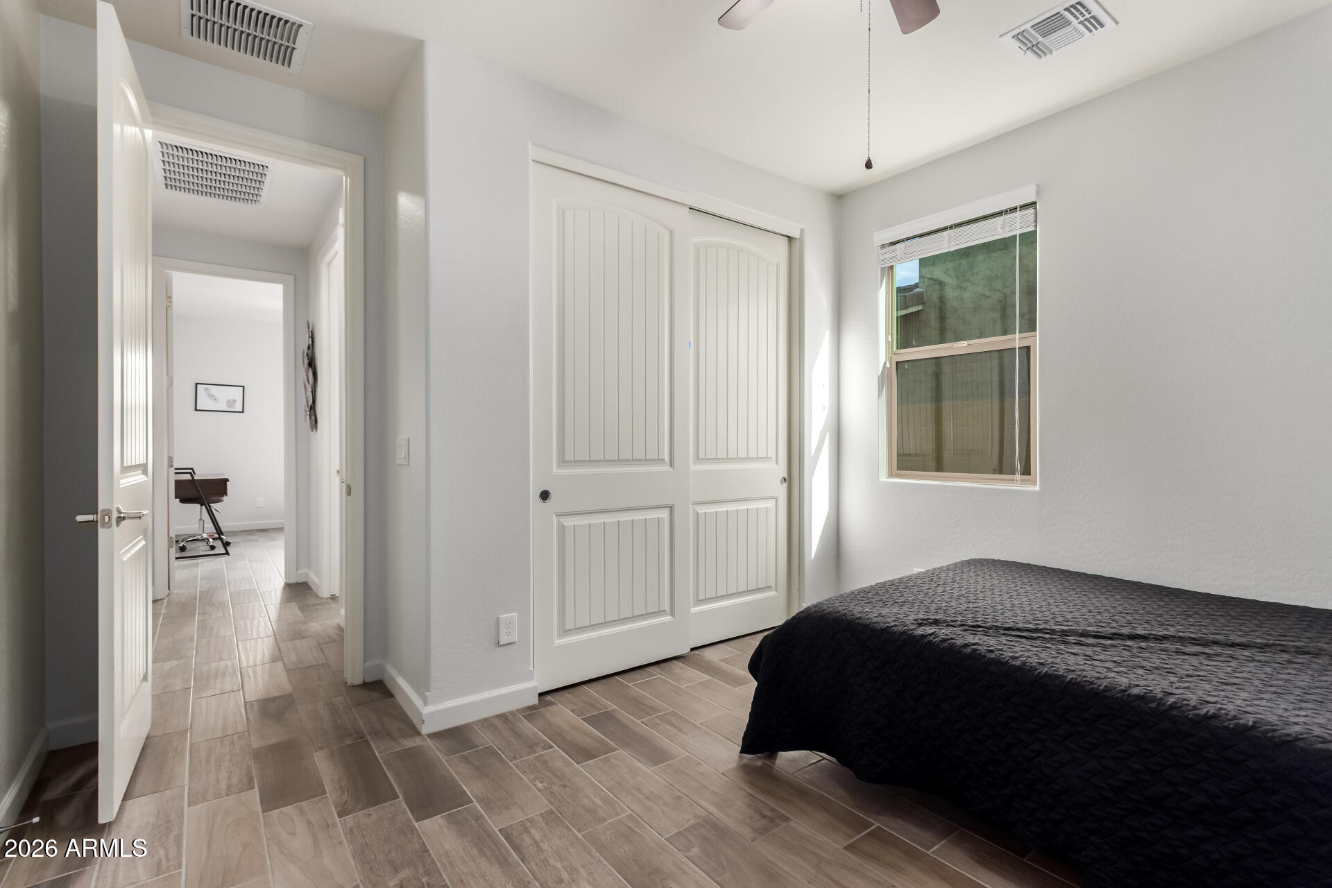 22083 East Camacho Road Queen Creek, AZ 85142 - Photo 29 of 42 a bedroom with a bed and a chandelier