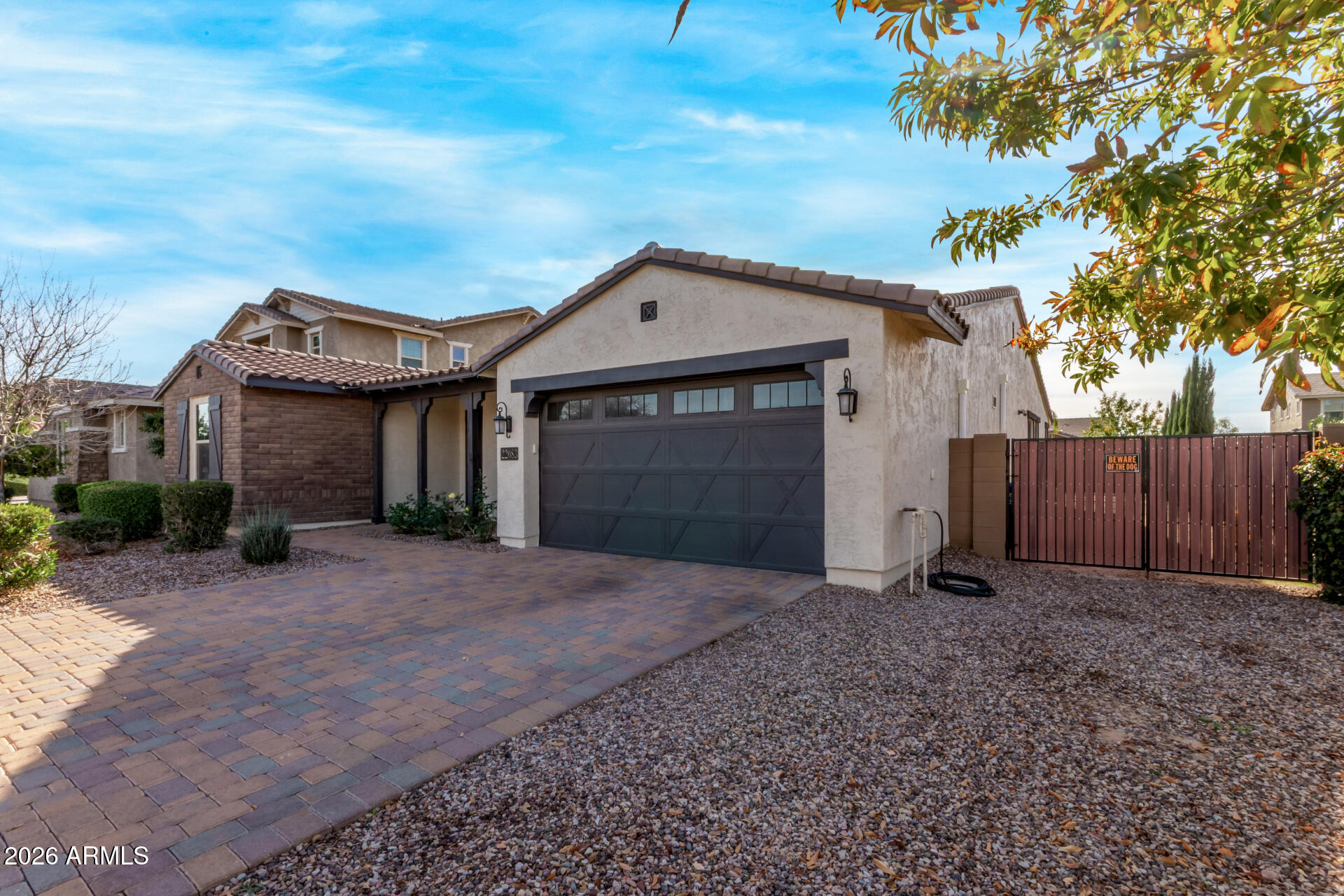 22083 East Camacho Road Queen Creek, AZ 85142 - Photo 5 of 42 a front view of a house with a garden