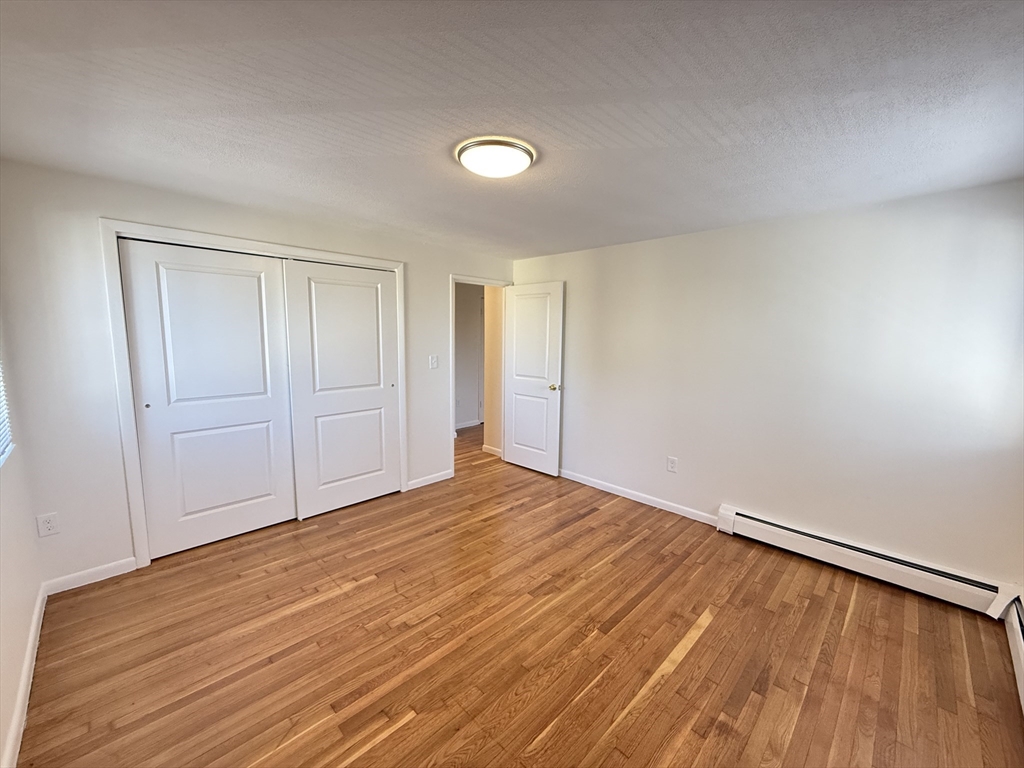 154 Main Street, Unit 32 Everett, MA 02149 - Photo 8 of 10 a view of an empty room and wooden floor