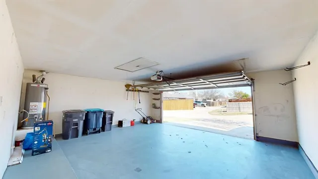 an empty room with wooden floor chandelier fan and windows