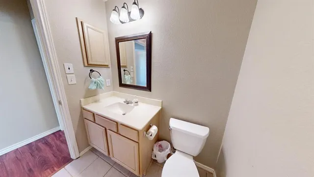 a bathroom with a toilet a sink and mirror
