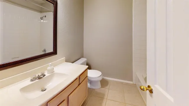 a bathroom with a toilet a sink and mirror