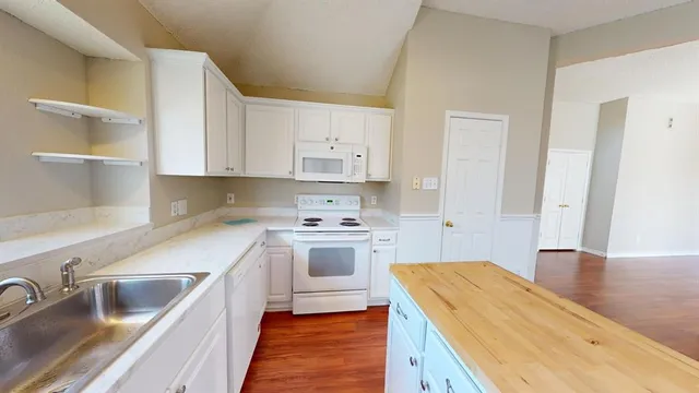 a kitchen with cabinets appliances and a window