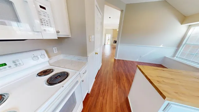 a kitchen with a sink stove top oven and cabinets