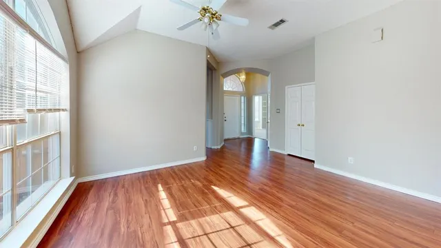 a view of a livingroom with wooden floor and a fireplace