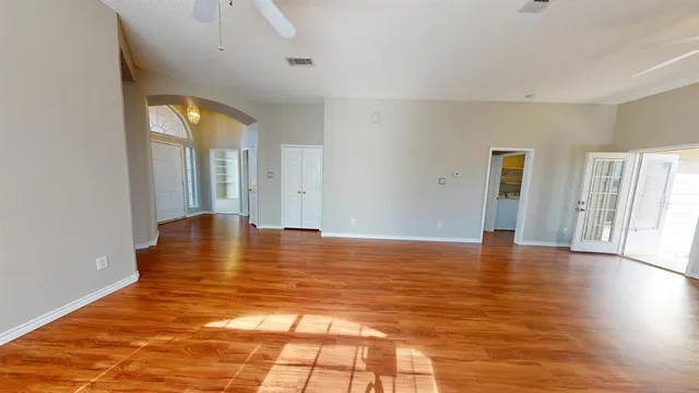 wooden floor in an empty room with a window
