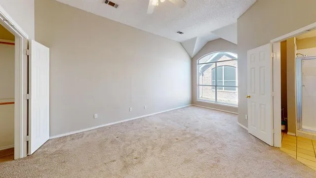 a bathroom with a tub mirror and toilet