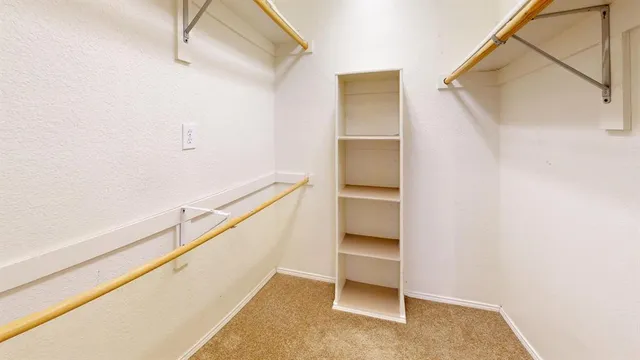 a view of an empty room with a ceiling fan