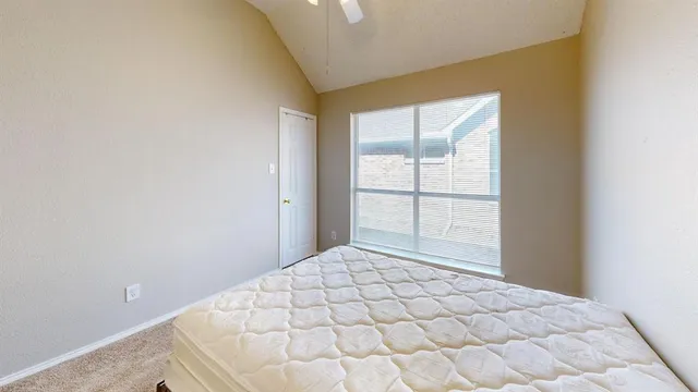 a bedroom with a bed and a mirror