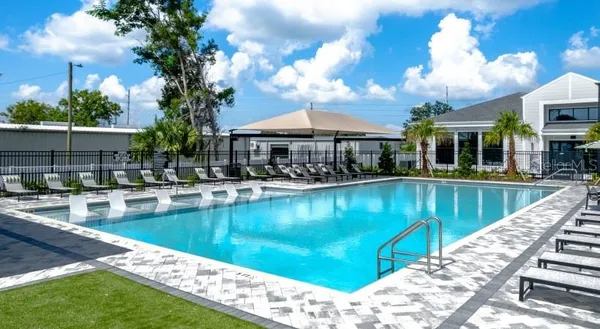 a view of a swimming pool with outdoor seating