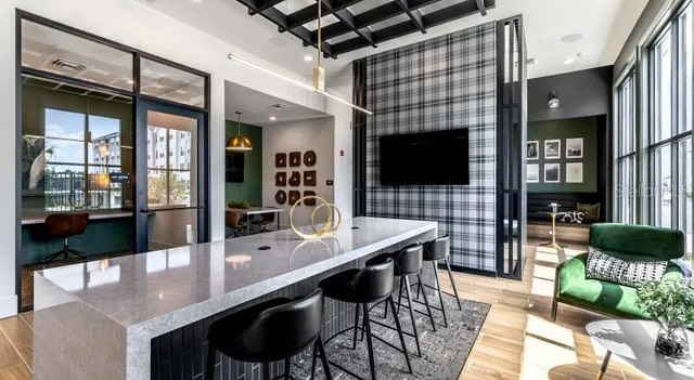 a dining room with furniture and a flat screen tv