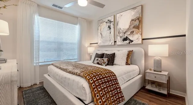 a bedroom with a bed and a painting on the wall