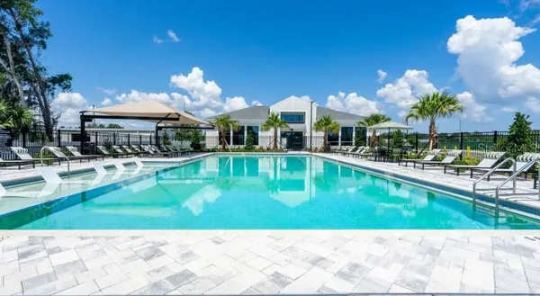 a swimming pool view with a seating space and a garden