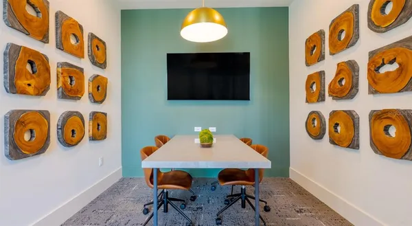 a view of a dining room with a table and chairs