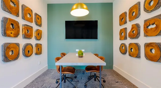 a view of a dining room with a table and chairs
