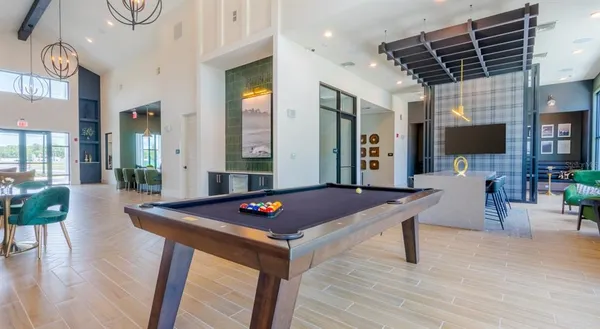 a living room with furniture a flat screen tv and a table