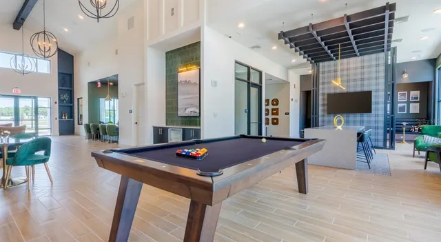 a living room with furniture a flat screen tv and a table