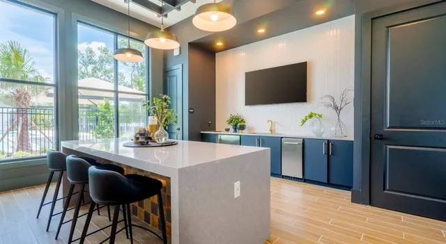 a dining room with furniture and a flat screen tv
