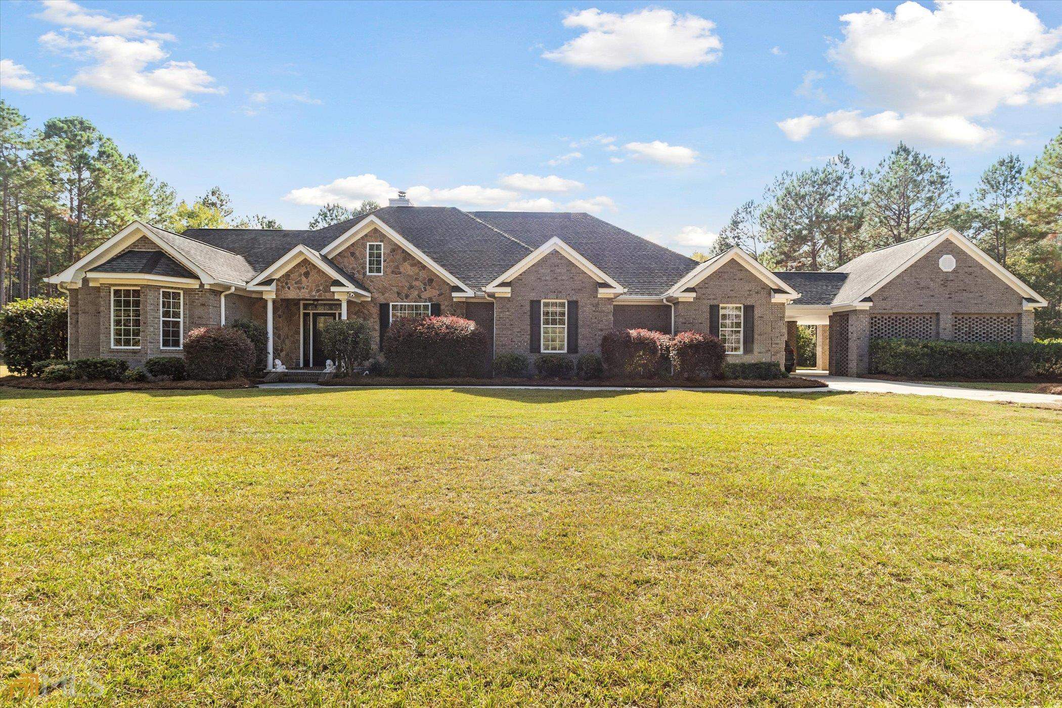 152 Herman Butler Road Pembroke, GA 31321 - Photo 1 of 1 a front view of a house with a yard