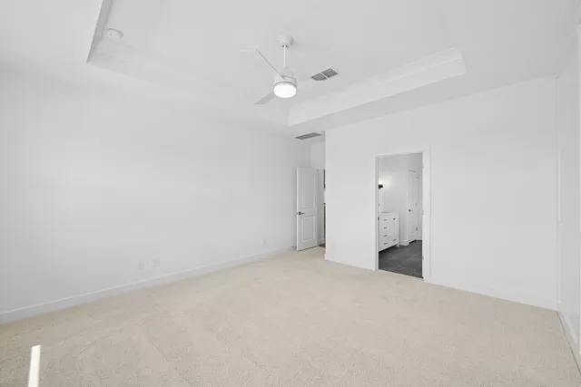 a view of an empty room with a ceiling fan