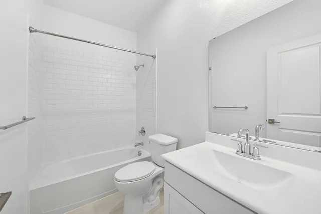 a bathroom with a toilet a sink and a bathtub