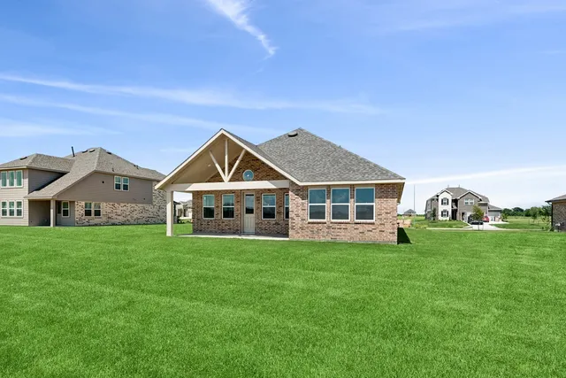 a front view of a house with a yard table and chairs