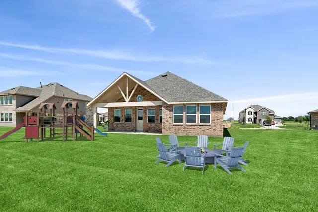a view of a house with a big yard and large trees