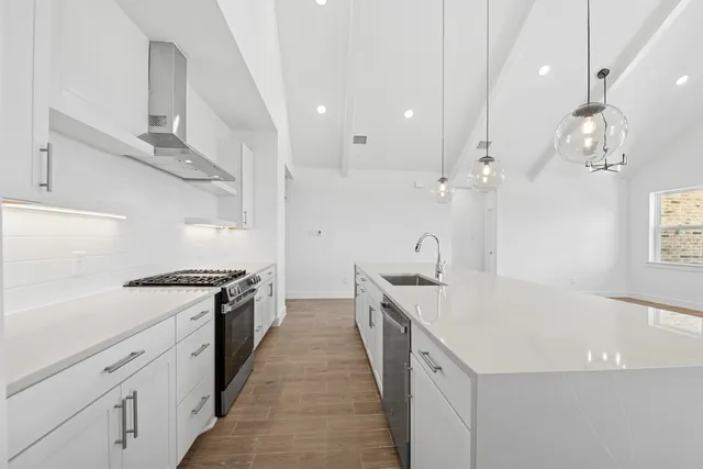 a kitchen with a sink a stove and chairs